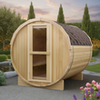 Load image into Gallery viewer, Wooden barrel-shaped sauna in a garden setting with trees and flowers.
