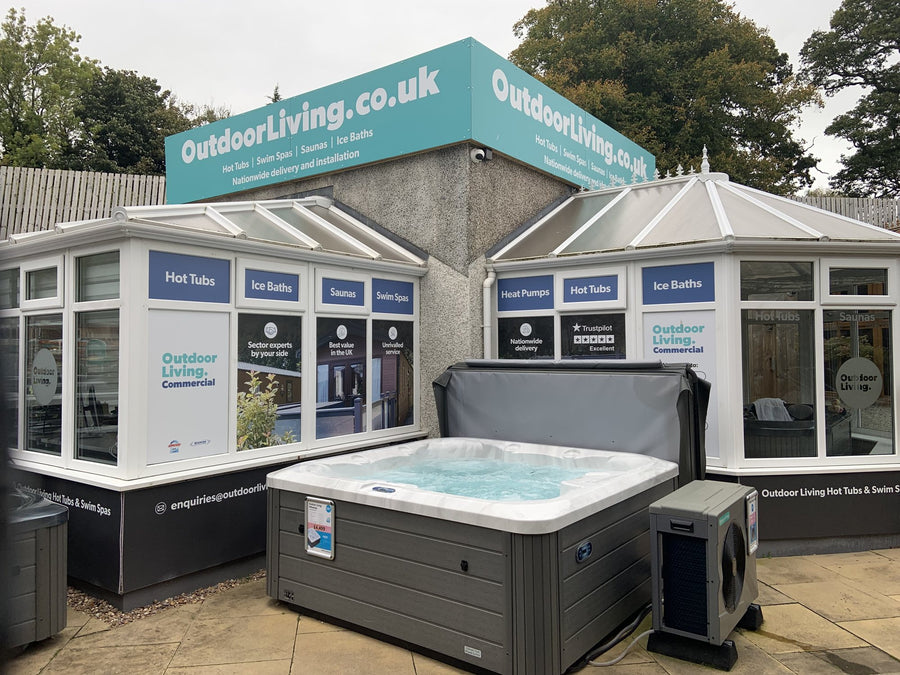 The Outdoor Living showroom frontage in Carlisle, with a hot tub on display beside the entrance