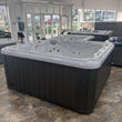 Load image into Gallery viewer, Hot tub in a showroom with large windows
