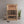 Load image into Gallery viewer, Infrared sauna in a room with a plant and a stool.
