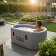 Load image into Gallery viewer, Person in an inflatable outdoor ice tub in a garden setting
