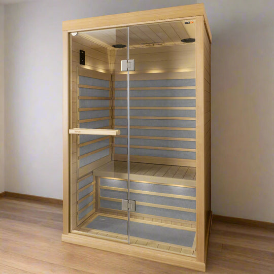 A 2-person infrared sauna made of clear Hemlock wood with glass panels, featuring a handle on the outside that appears to be a towel rack, and LED lighting inside.
