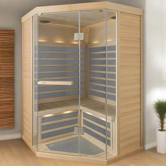 A 3-person infrared corner sauna made of light-colored wood, with clear glass doors and built into a corner space.