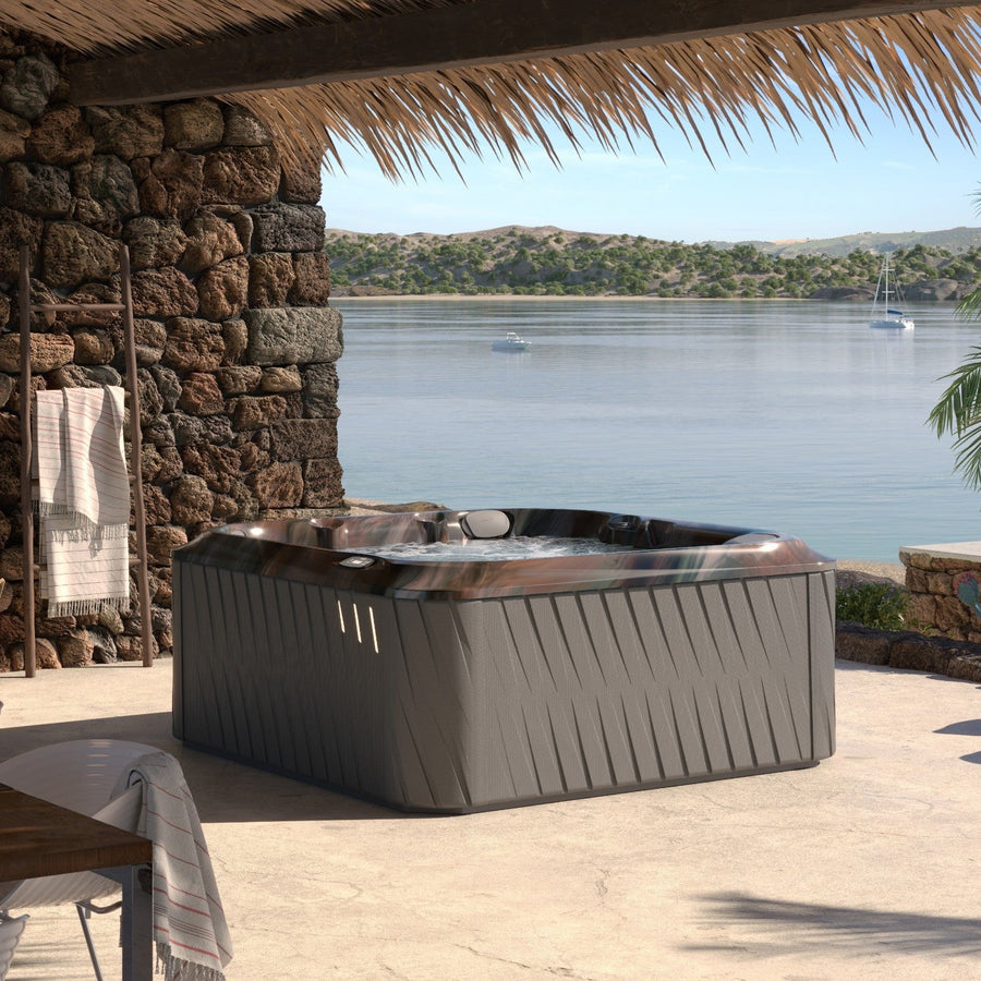 Jacuzzi J-235 hot tub in a garden setting (brand lifestyle image)