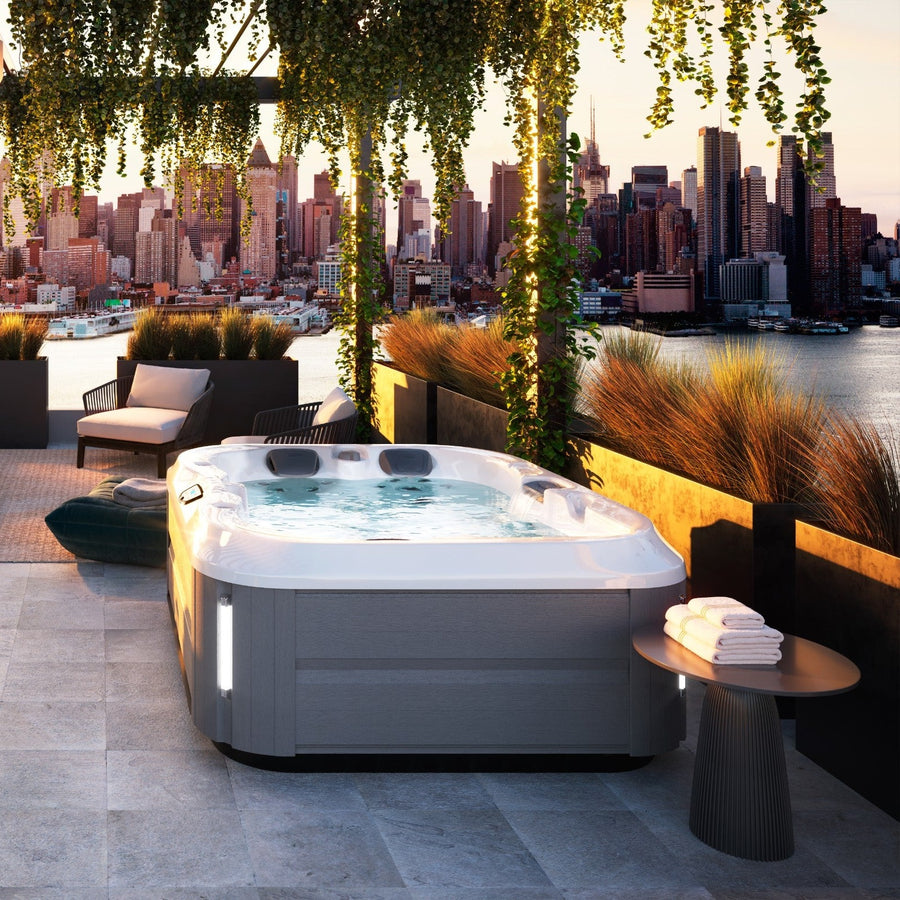 Jacuzzi J-315 hot tub in a garden setting (brand lifestyle image)