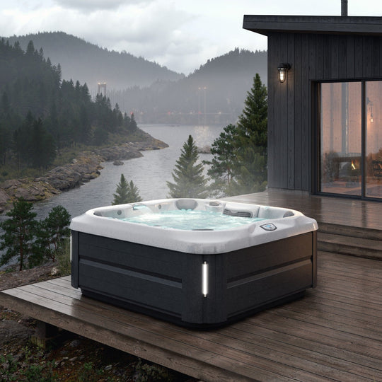 Jacuzzi J-345 hot tub in a planted courtyard garden (brand lifestyle image)