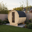 Load image into Gallery viewer, Illustrative lifestyle view of the Outdoor Living barrel outdoor sauna in a UK garden
