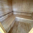 Load image into Gallery viewer, Inside corner of the Outdoor Living Cube sauna showing both benches
