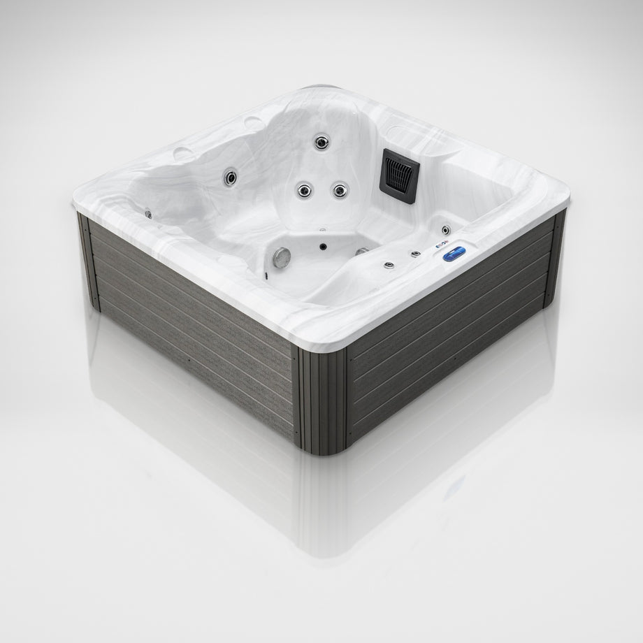 The Outdoor Living Escape hot tub in Silver Marble with a grey cabinet, seen from a three-quarter angle in the studio