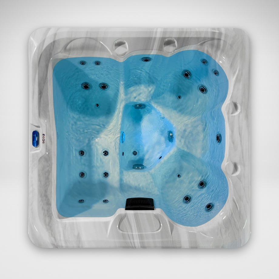 The Outdoor Living Escape hot tub seen from above, filled and lit