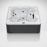 Load image into Gallery viewer, The Outdoor Living Hideaway hot tub in Silver Marble with a grey cabinet, seen from the front in the studio