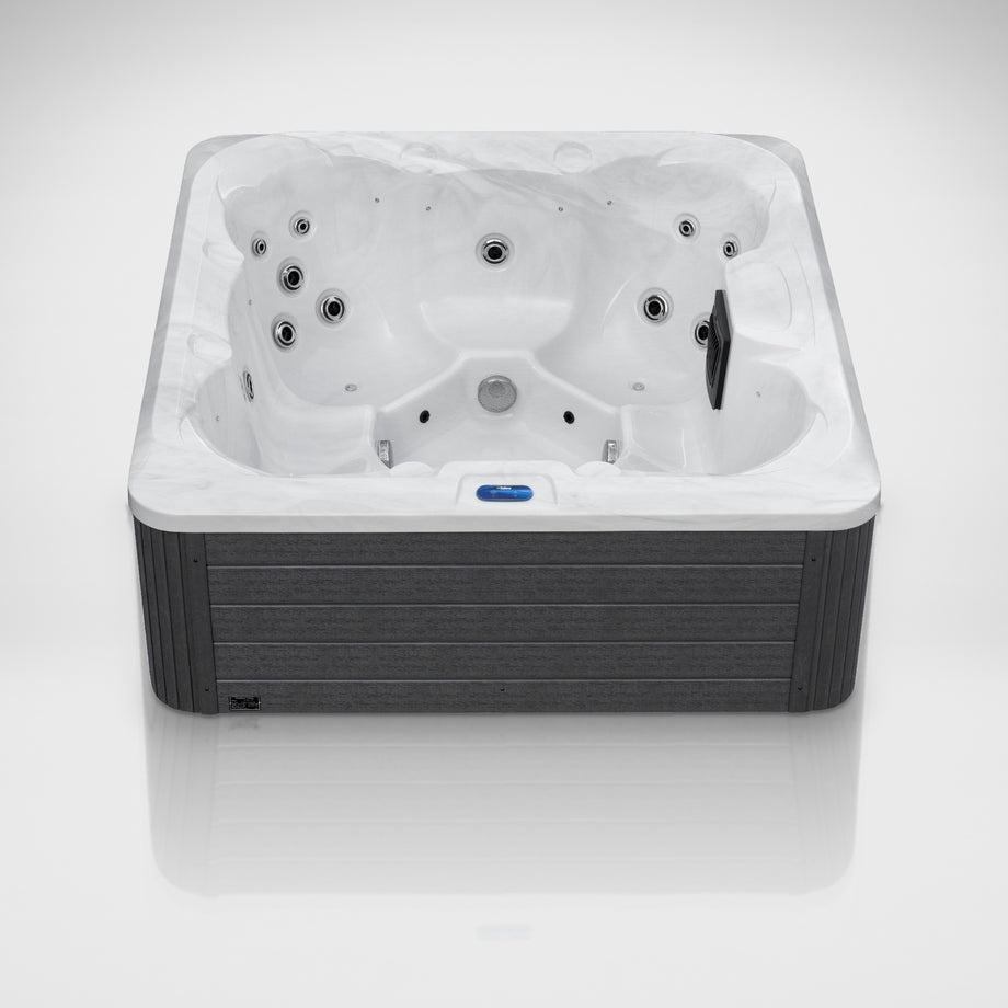 The Outdoor Living Hideaway hot tub in Silver Marble with a grey cabinet, seen from the front in the studio