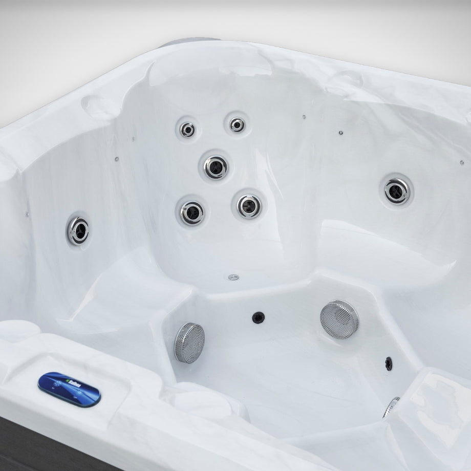Close-up of the seats, jets and guest control panel inside the Outdoor Living Hideaway hot tub