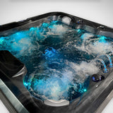 Load image into Gallery viewer, Close-up of the Outdoor Living Lagoon with jets, fountains and blue LED lighting