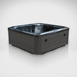Load image into Gallery viewer, The Outdoor Living Lagoon hot tub in Midnight Opal with a grey cabinet, seen from a three-quarter angle in the studio