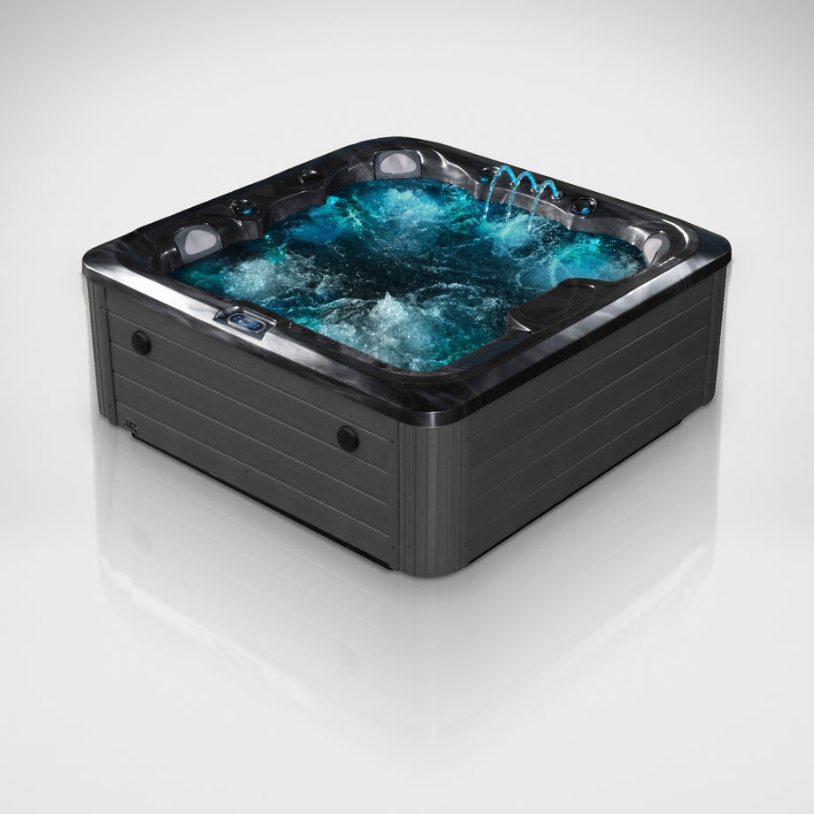 The Outdoor Living Lagoon hot tub in Midnight Opal with the jets, fountain and lights on