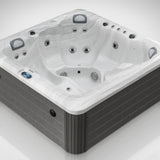 Load image into Gallery viewer, The Outdoor Living Lagoon hot tub in Silver Marble with a grey cabinet, close up from a three-quarter angle in the studio