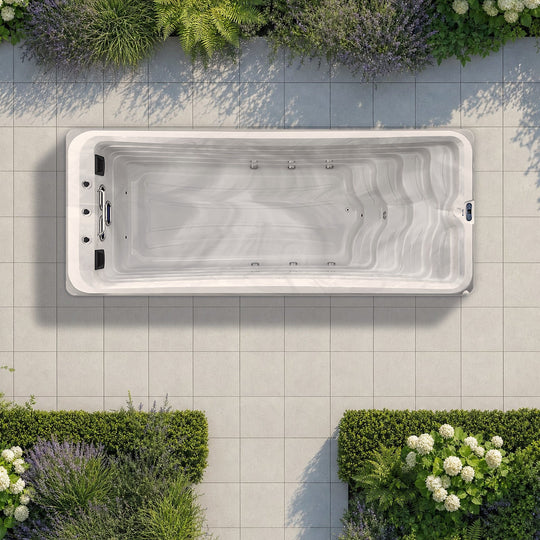The Outdoor Living Mini Pool seen from above on a planted garden terrace, drawn to true scale on 60 cm paving slabs