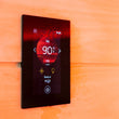 Load image into Gallery viewer, Harvia Fenix Wi-Fi touch control panel on a sauna wall showing 90°C

