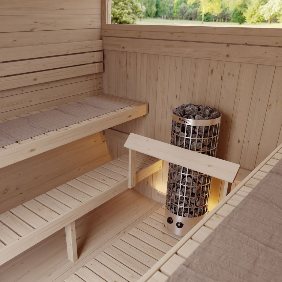 Harvia Cilindro heater inside a timber sauna between the benches
